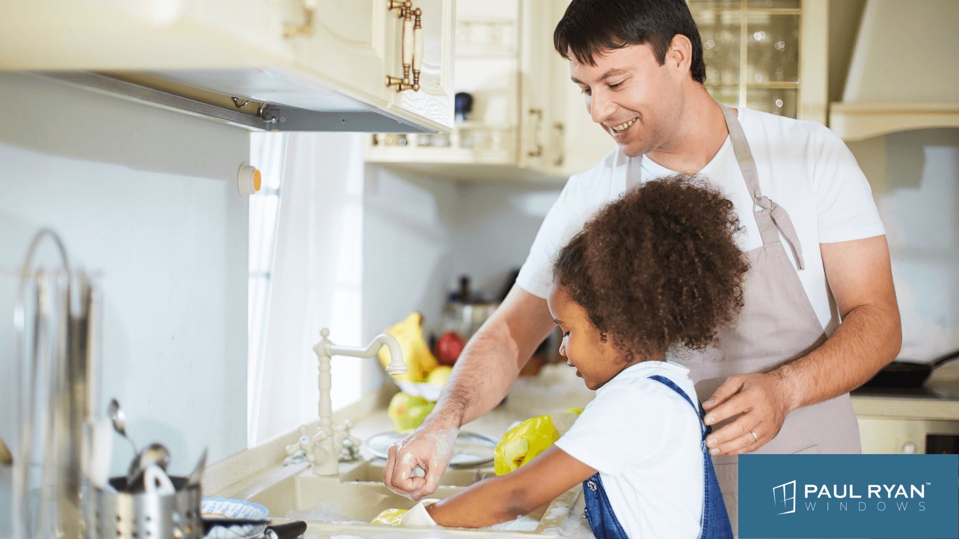 An image of a father washing dishes with his daughter